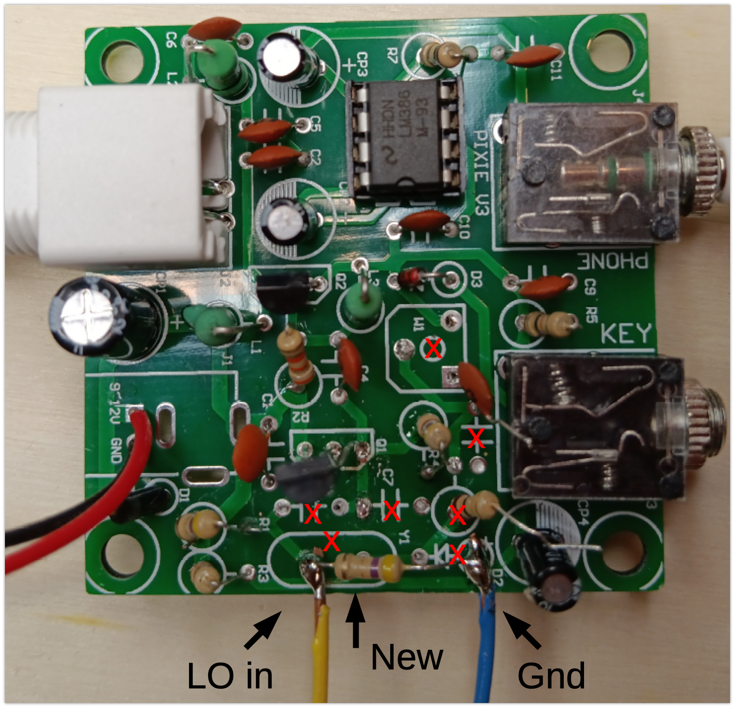 Photo of the modified Pixie board, showing seven components that were removed (two were half-removed), one new resistor, and the wires for LO in and ground from th